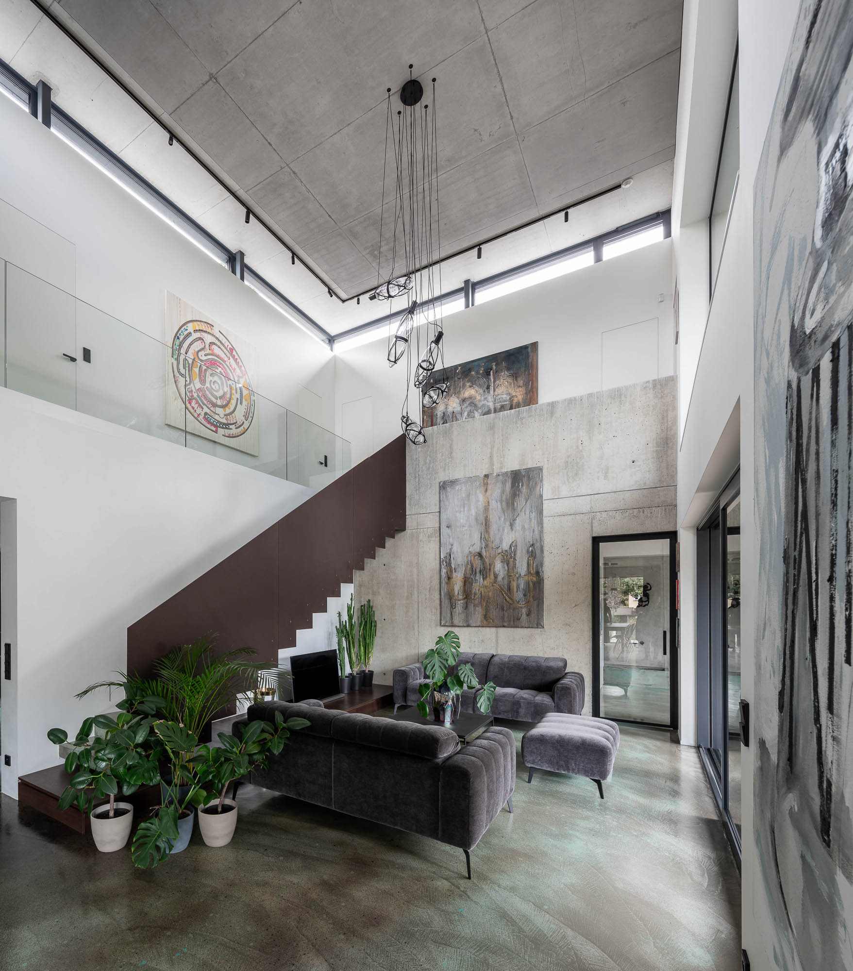 Villa Lučiny interior — living room with cantilevered staircase OOOOX Prague