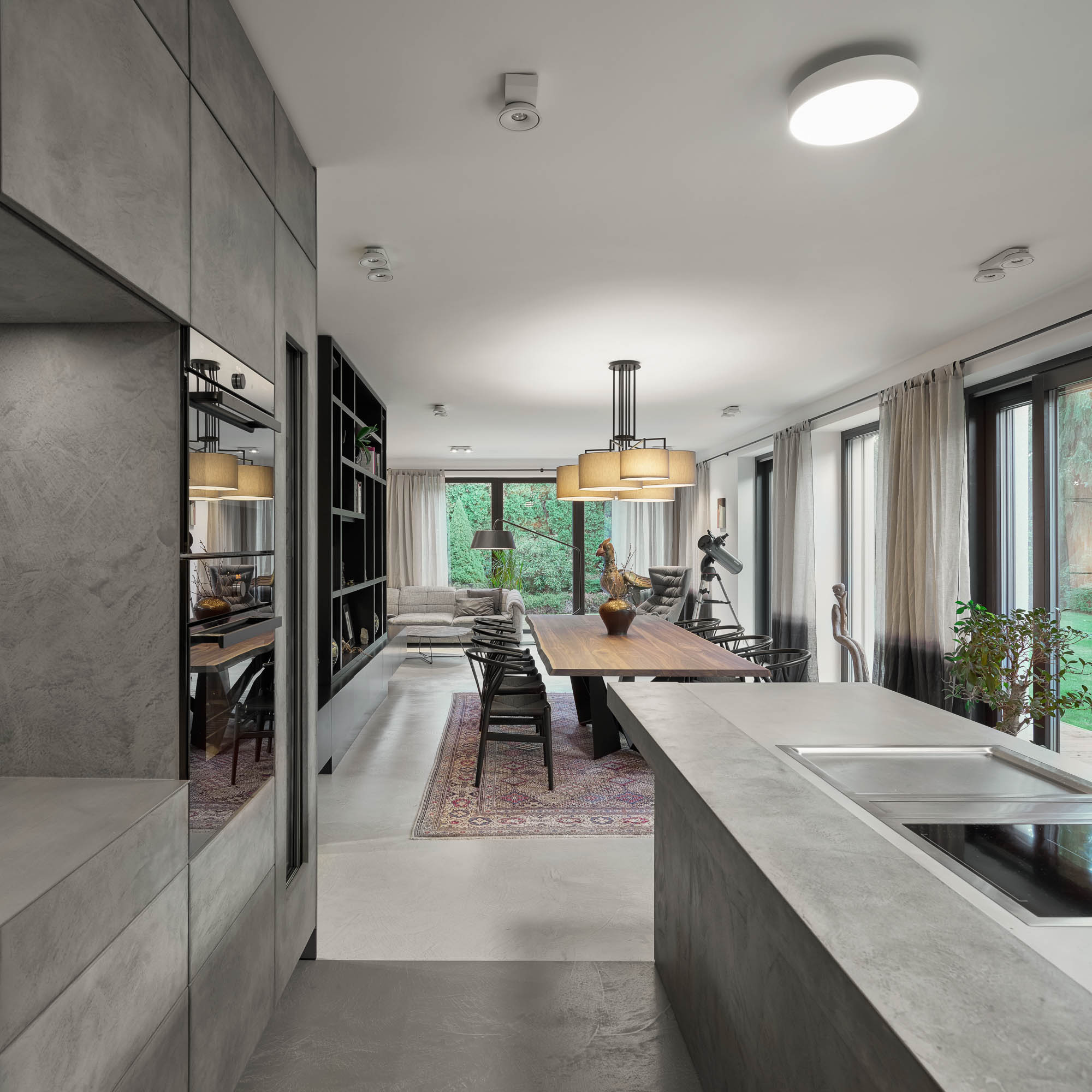 Kitchen grey stucco wall oak island view into dining room chandelier garden linen curtains OOOOX