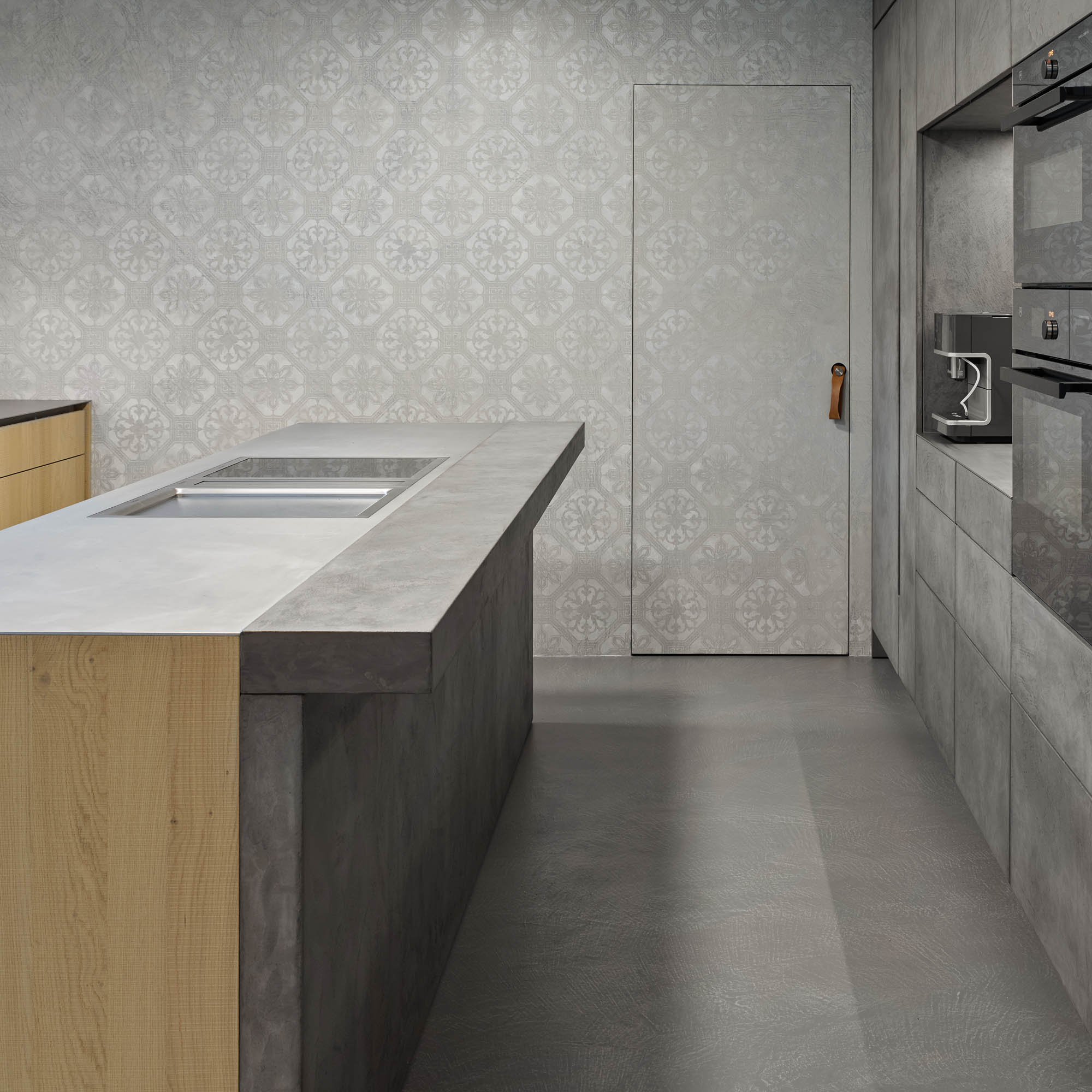 Kitchen hidden pantry door leather pull handle patterned stucco wall oak island stainless countertop OOOOX