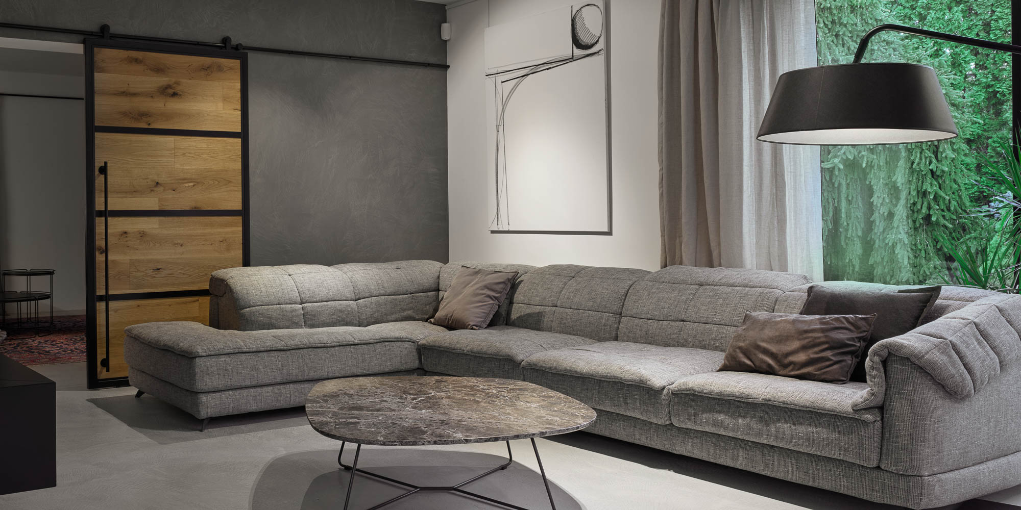 Living room grey L-shaped sectional sofa dark marble coffee table barn sliding door abstract art floor lamp OOOOX