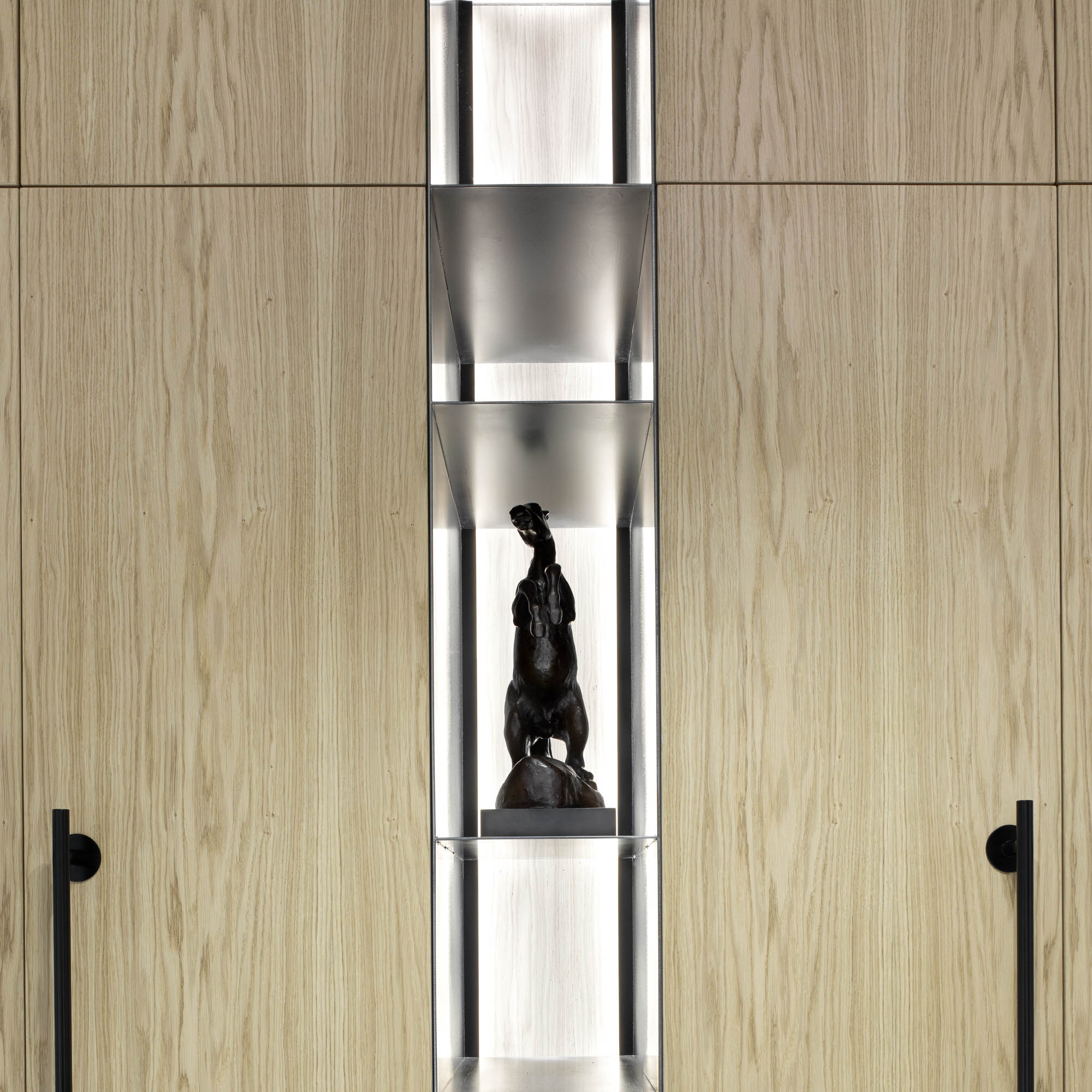Entrance hall oak veneer wall panel illuminated display niche bronze horse sculpture black round handles OOOOX