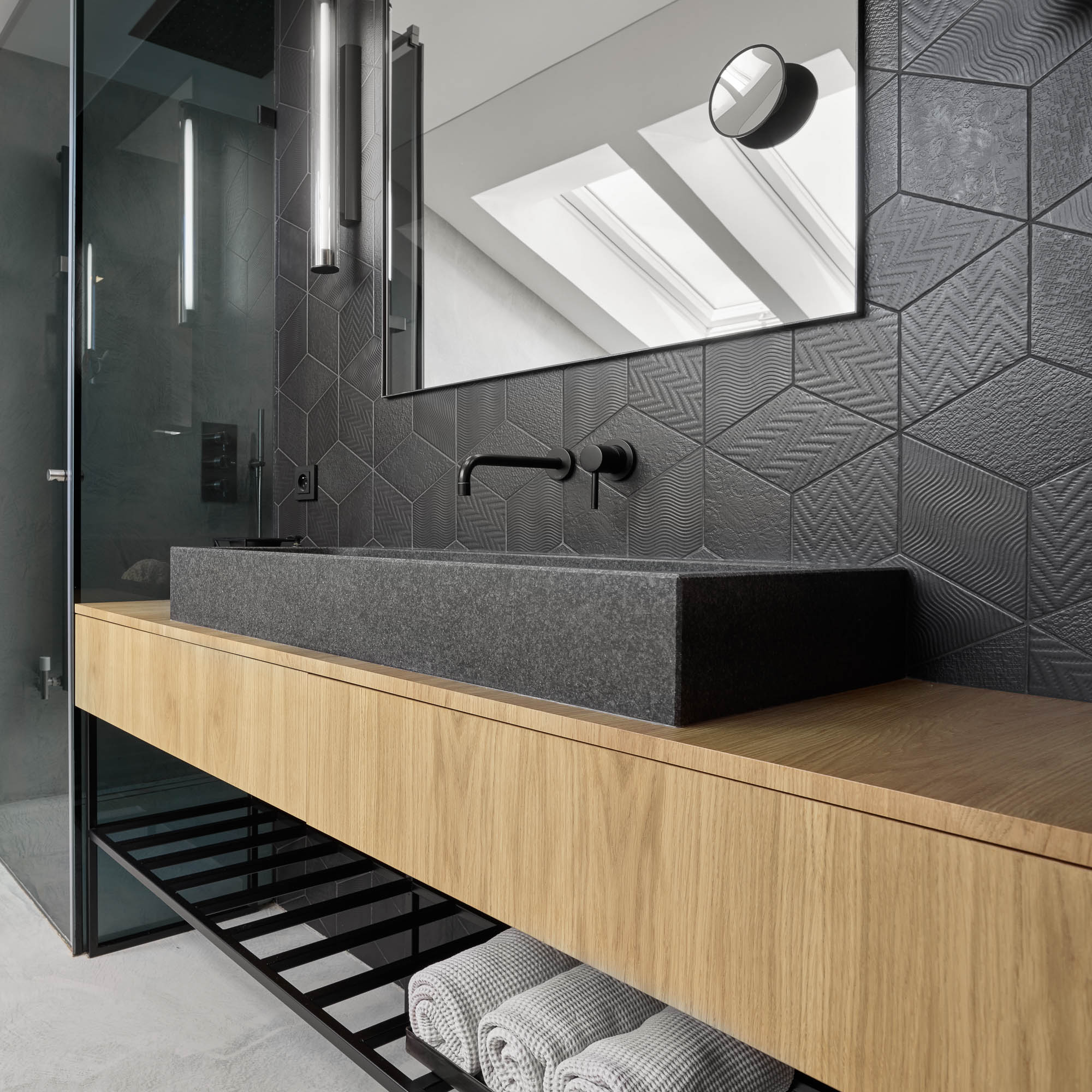 Bathroom stone vessel sink oak vanity black wall faucet dark geometric tile large mirror skylight OOOOX
