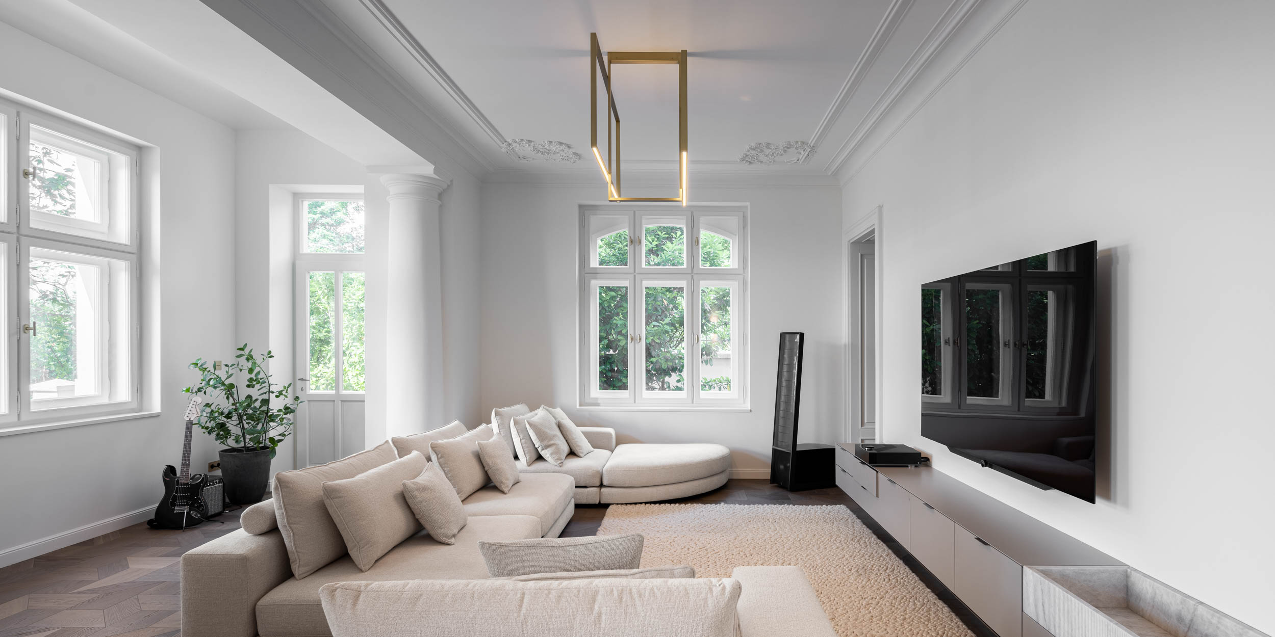 Living space of the minimalist interior reconstruction of Villa Vinohrady, stucco ceilings and delicate designer lighting | design by OOOOX