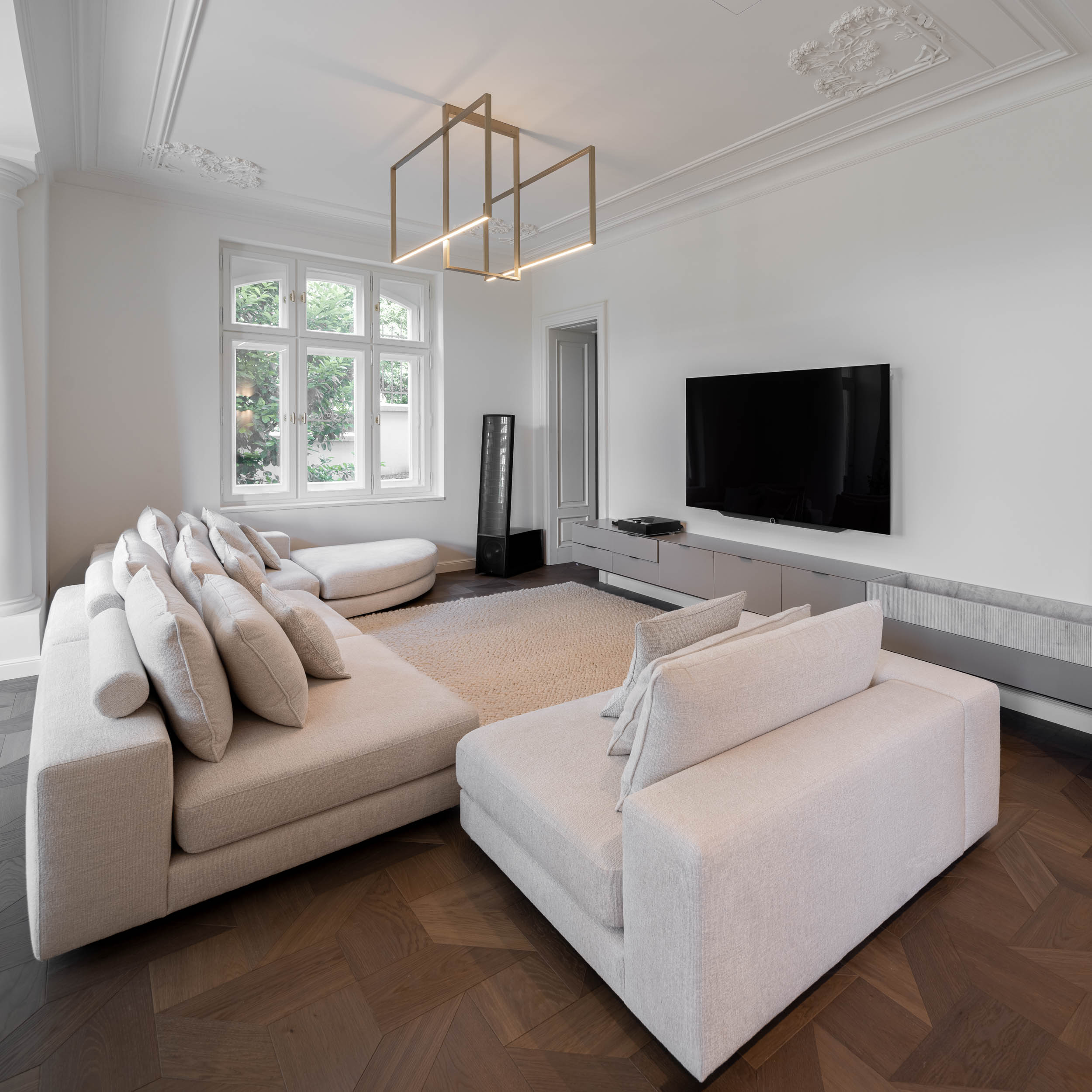 Living space of the minimalist interior reconstruction of Villa Vinohrady, stucco ceilings and delicate designer lighting | design by OOOOX