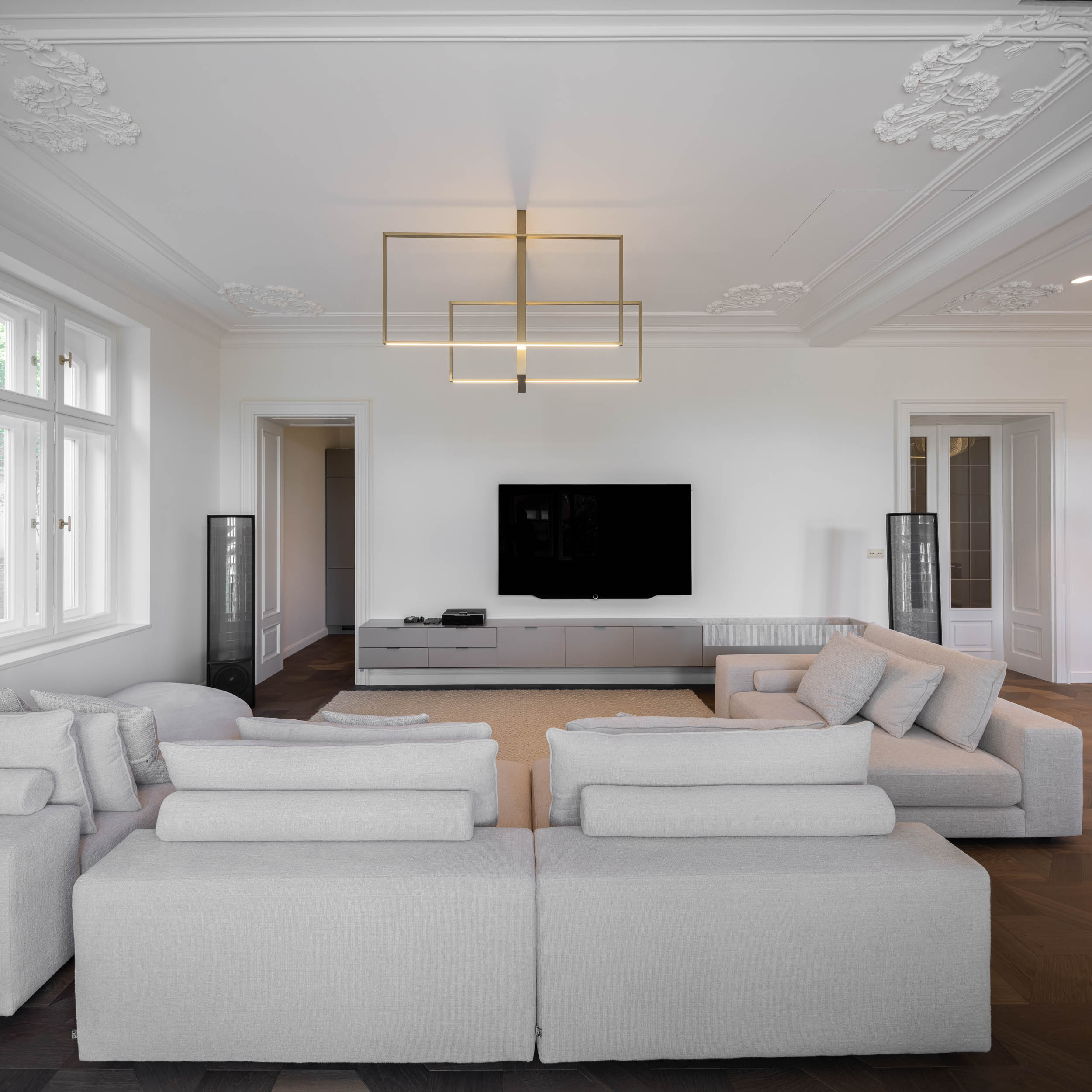 Living space of the minimalist interior reconstruction of Villa Vinohrady, stucco ceilings and delicate designer lighting | design by OOOOX