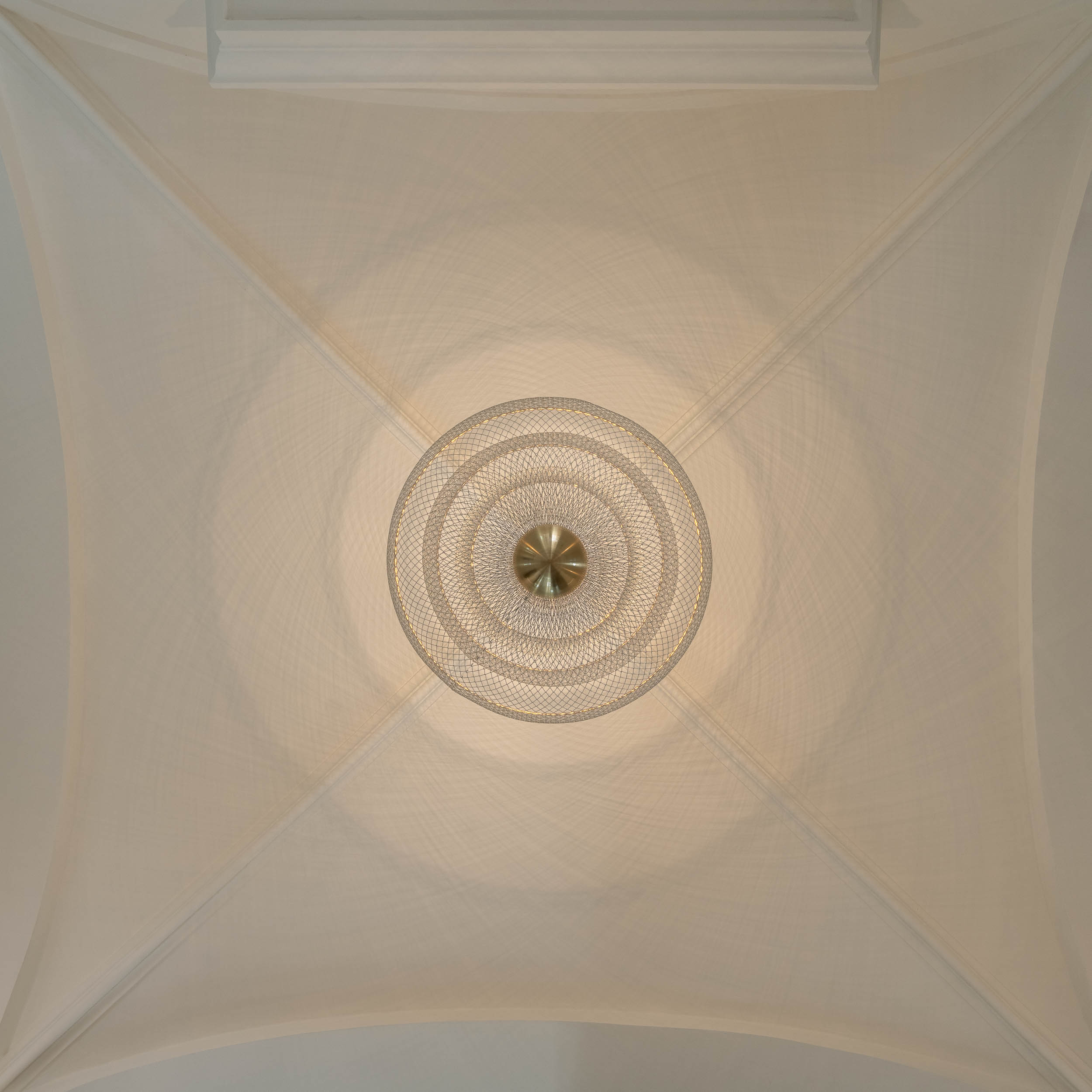 Detail of a wire designer chandelier suspended from the vaulted ceiling in the entrance area of Villa Vinohrady | reconstruction design by OOOOX