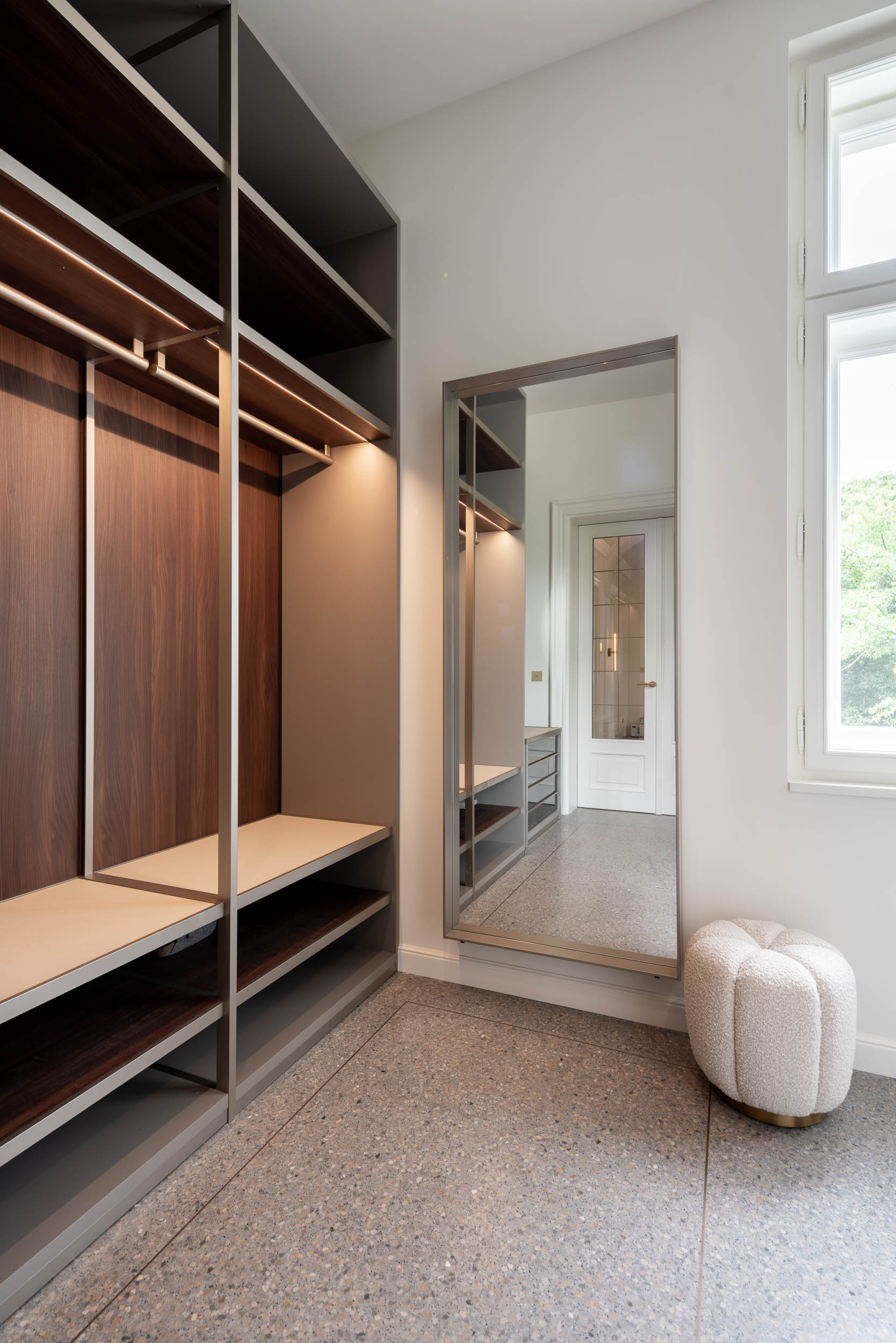 Wardrobe and large mirror in the minimalist interior of Villa Vinohrady | OOOOX