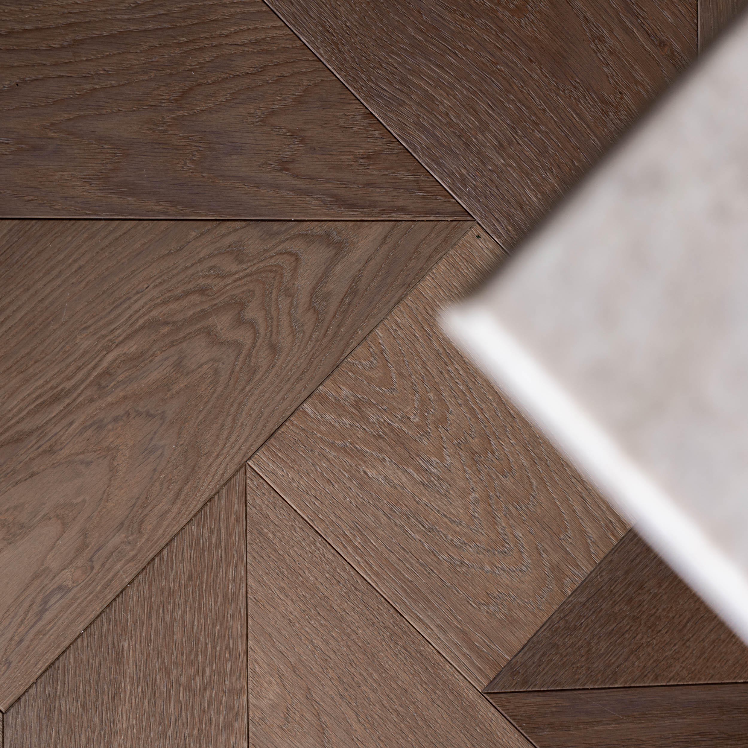 Detail of the dining table connection to custom American walnut parquet flooring | Villa Vinohrady reconstruction design | OOOOX