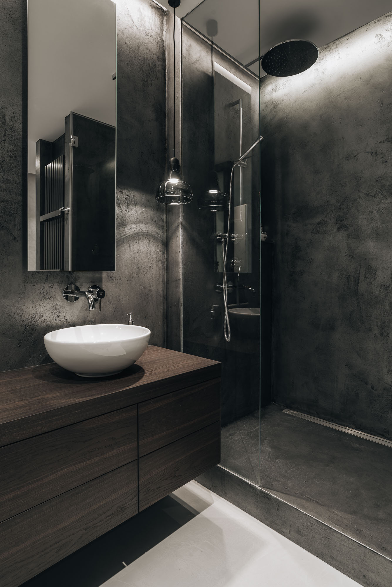 dark bathroom with plaster finish and two washbasins | OOOOX