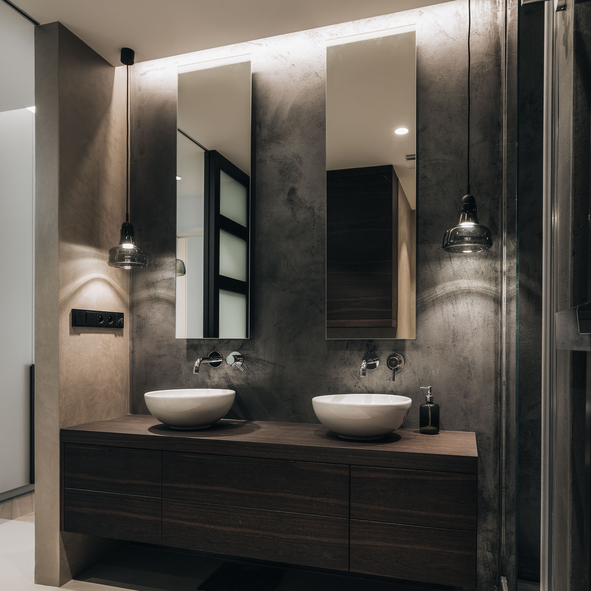 dark bathroom with plaster finish and two washbasins | OOOOX