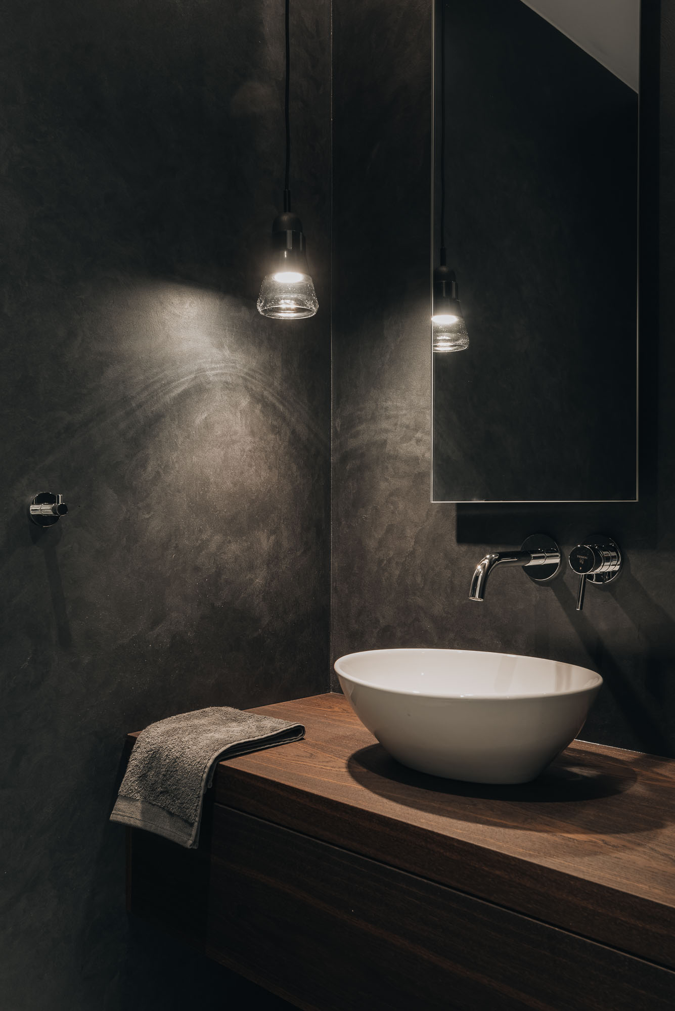 dark bathroom with plaster finish and two washbasins | OOOOX