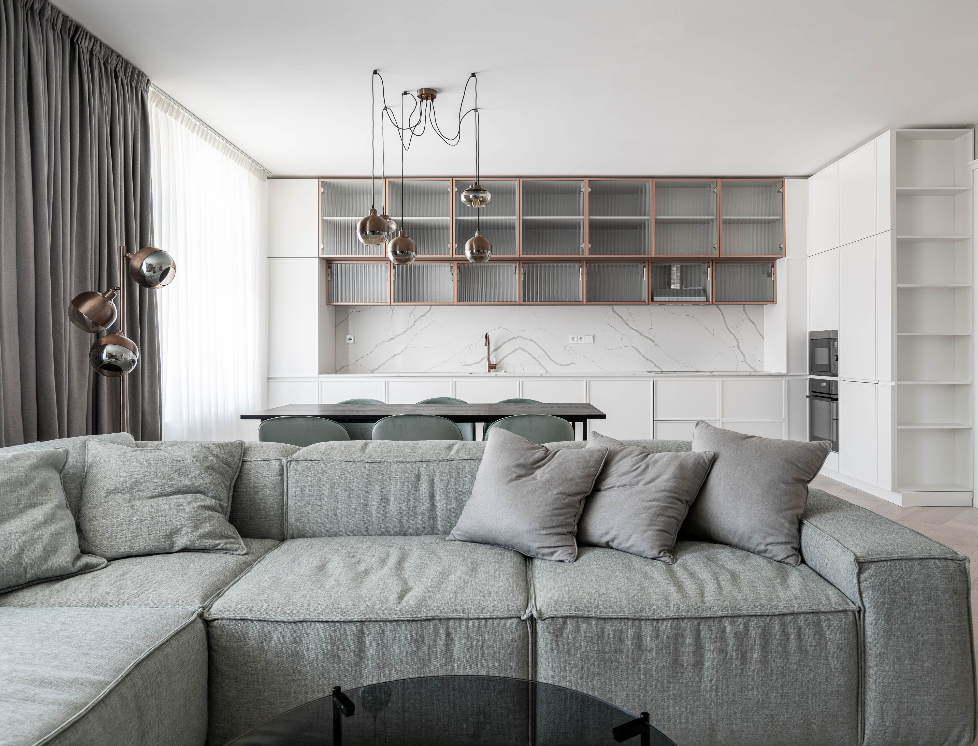 Image - (Gallery) Living room with white kitchen and copper details