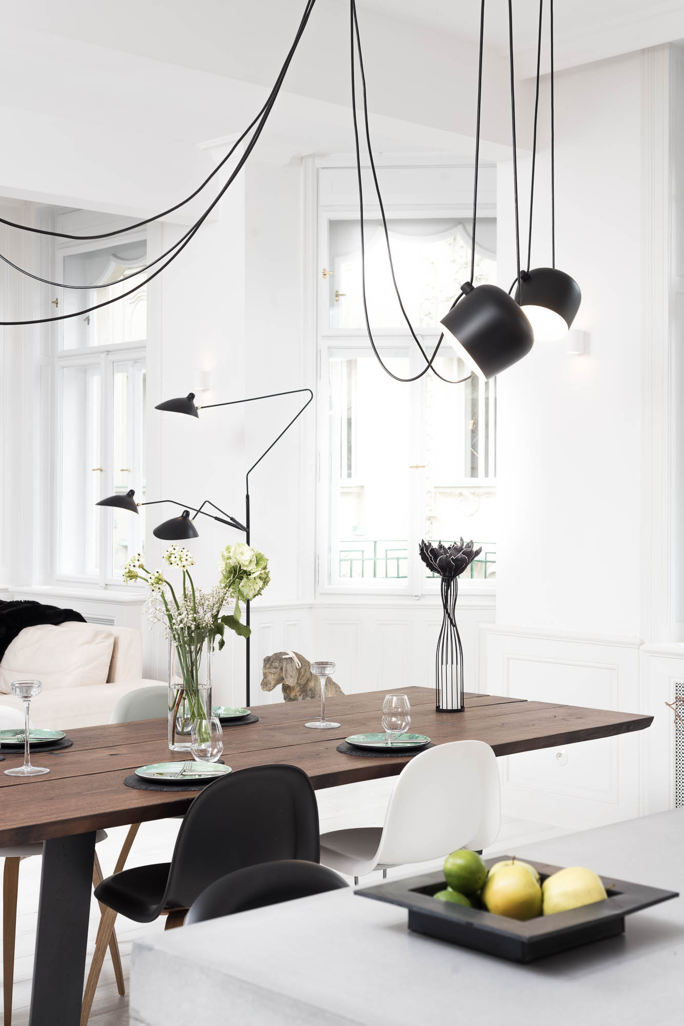 Detail of a three-metre solid walnut dining table and designer light fixture above the table | Art Nouveau apartment interior reconstruction by OOOOX