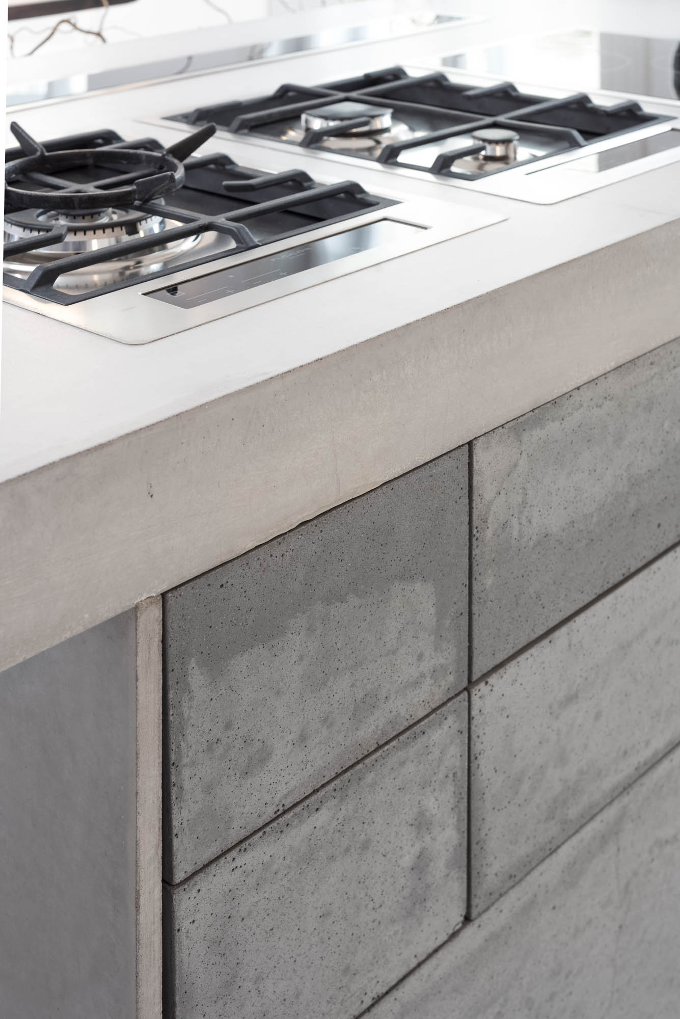 Detail of a kitchen island made from cast concrete slabs | Art Nouveau apartment reconstruction design by OOOOX