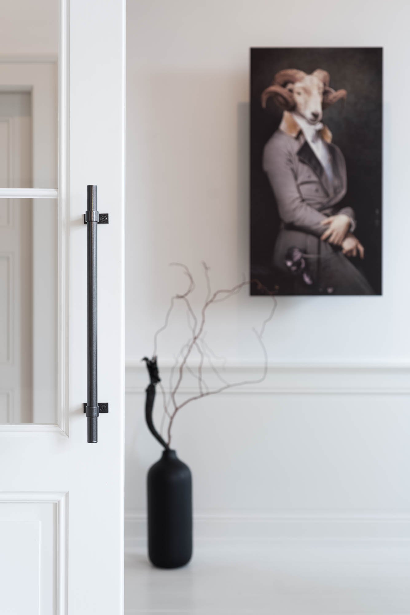 Detail of a designer door handle and designer planter in the hallway of an Art Nouveau apartment | OOOOX