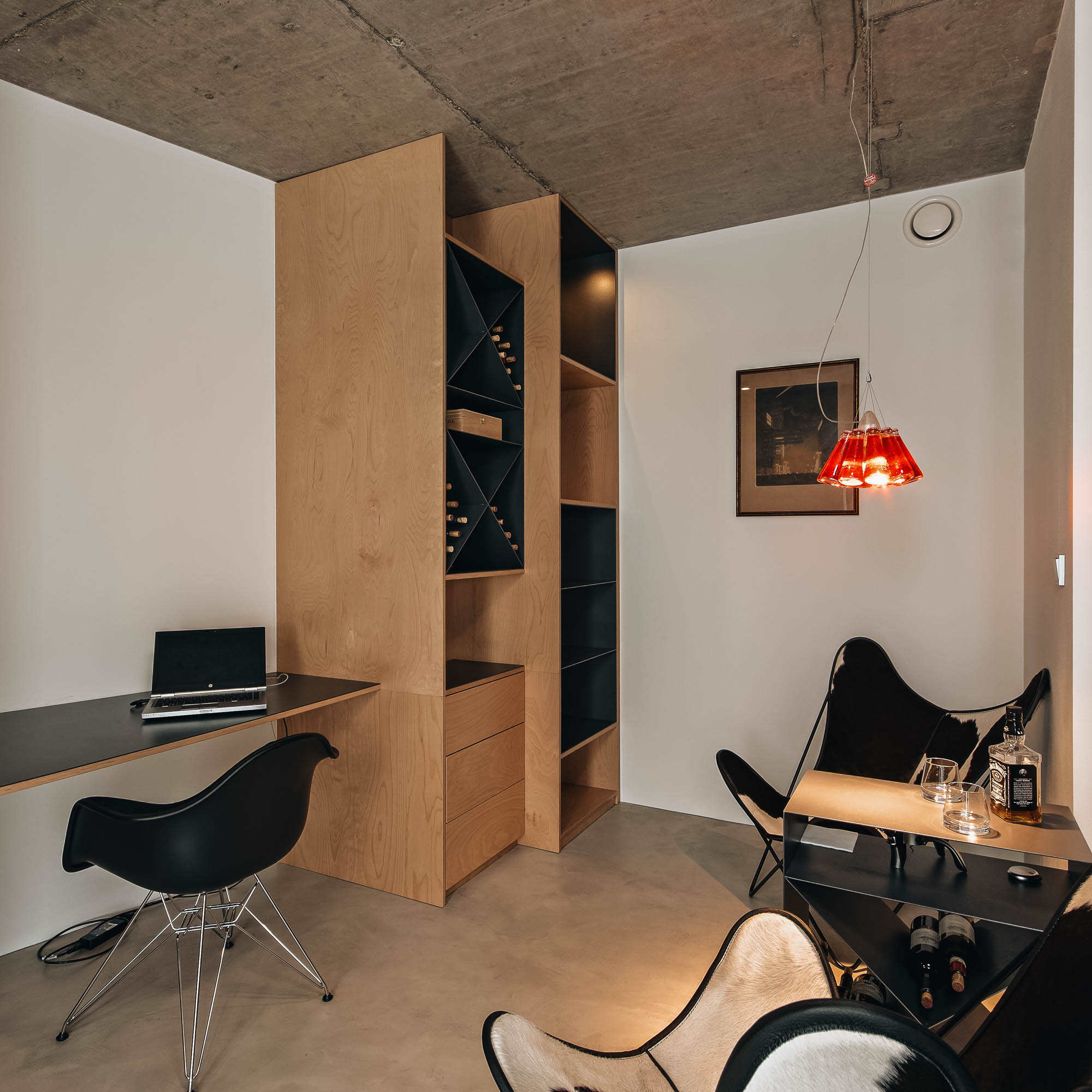 Kuřárna vily se sezením – motýlkové křeslo, červené svítidlo a přiznaný beton, návrh interiéru OOOOX