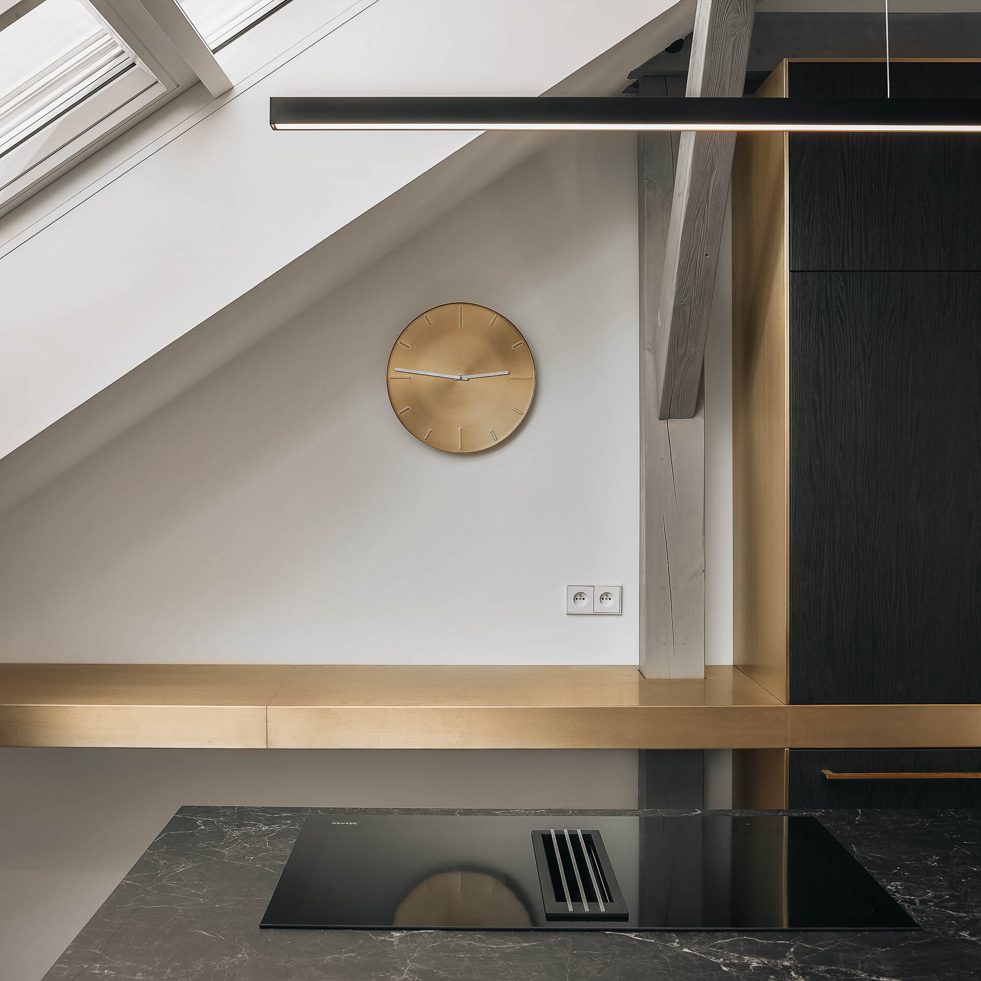 Clean lines and material connections in the kitchen cabinetry of the Josefov attic apartment | design by OOOOX