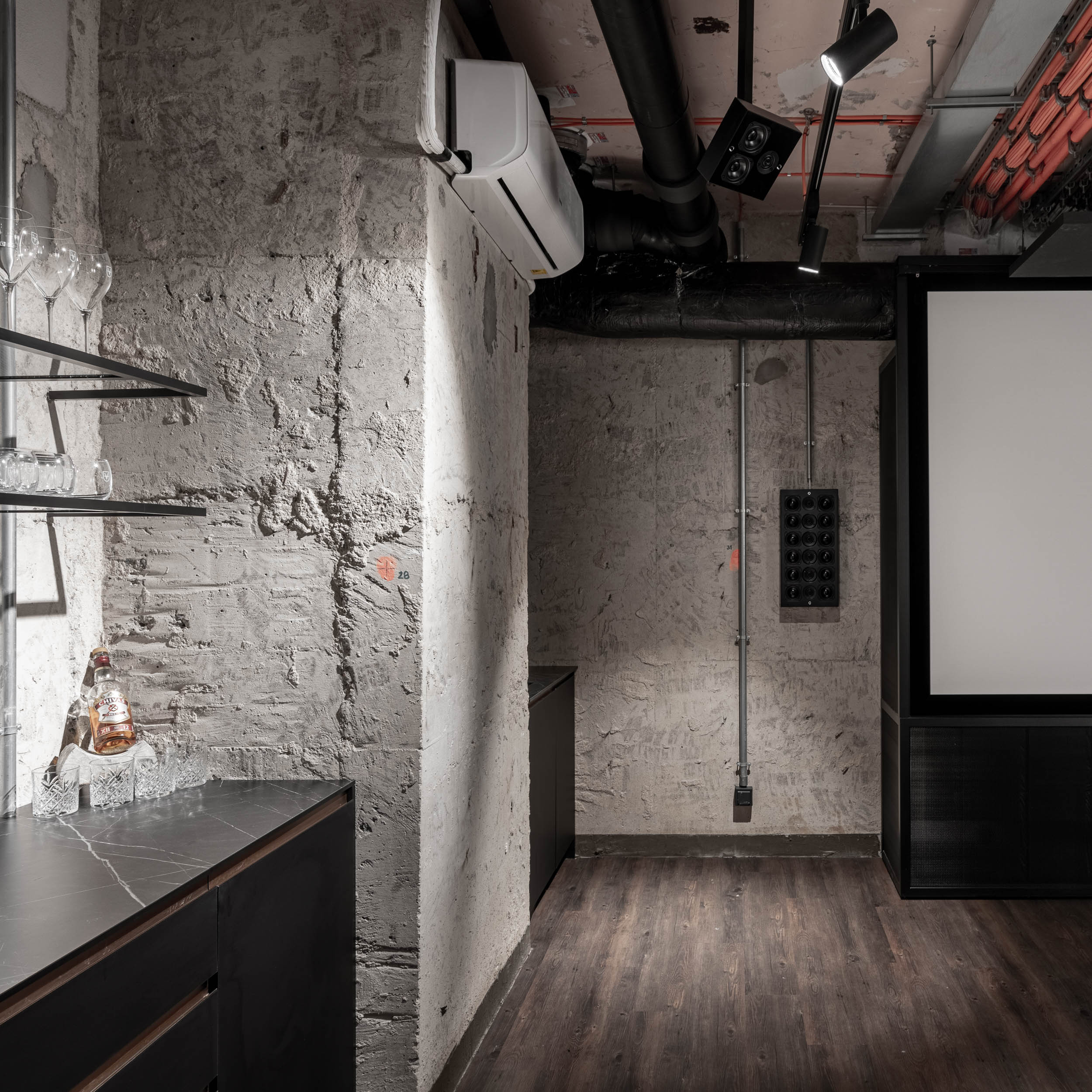 VANGUARD wellness private cinema — projection screen, raw concrete and plastered walls, exposed pipes, whisky bar, industrial atmosphere | OOOOX