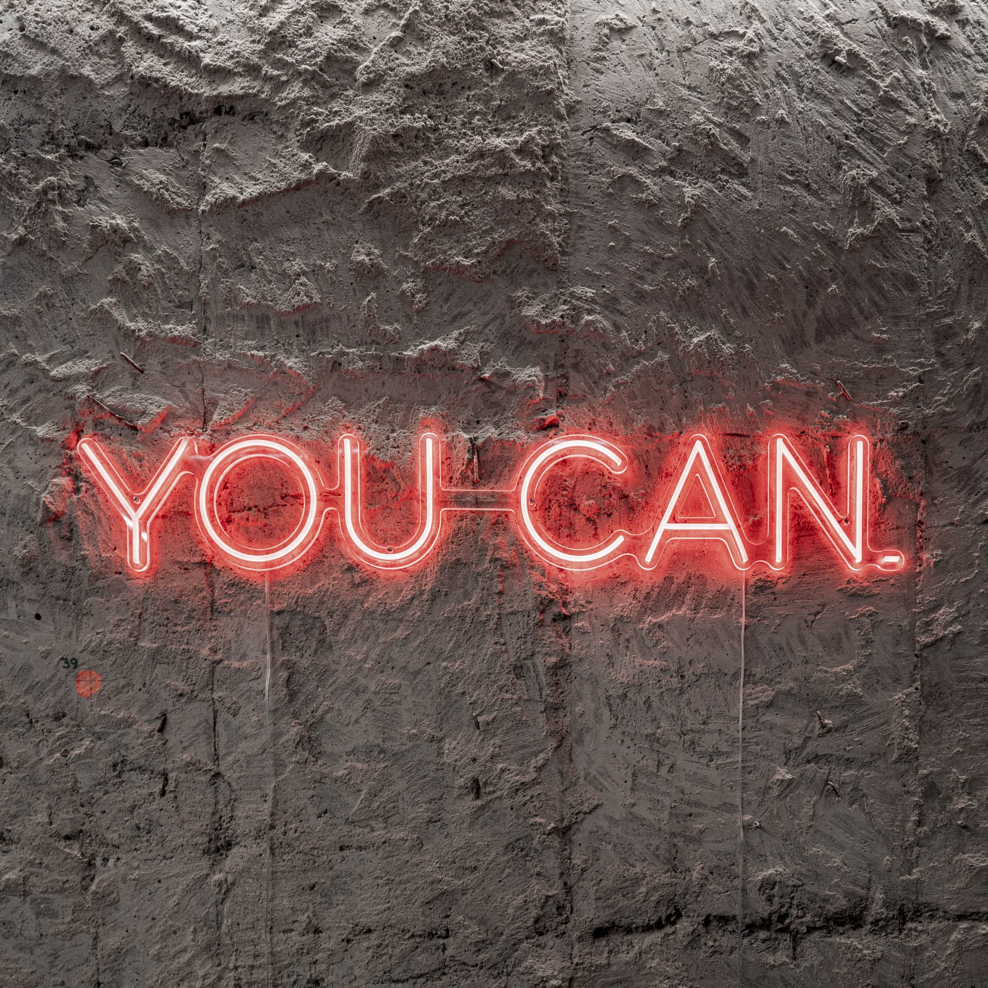 VANGUARD wellness gym neon sign YOU CAN — red neon on raw textured concrete wall of original bunker, motivational design | OOOOX
