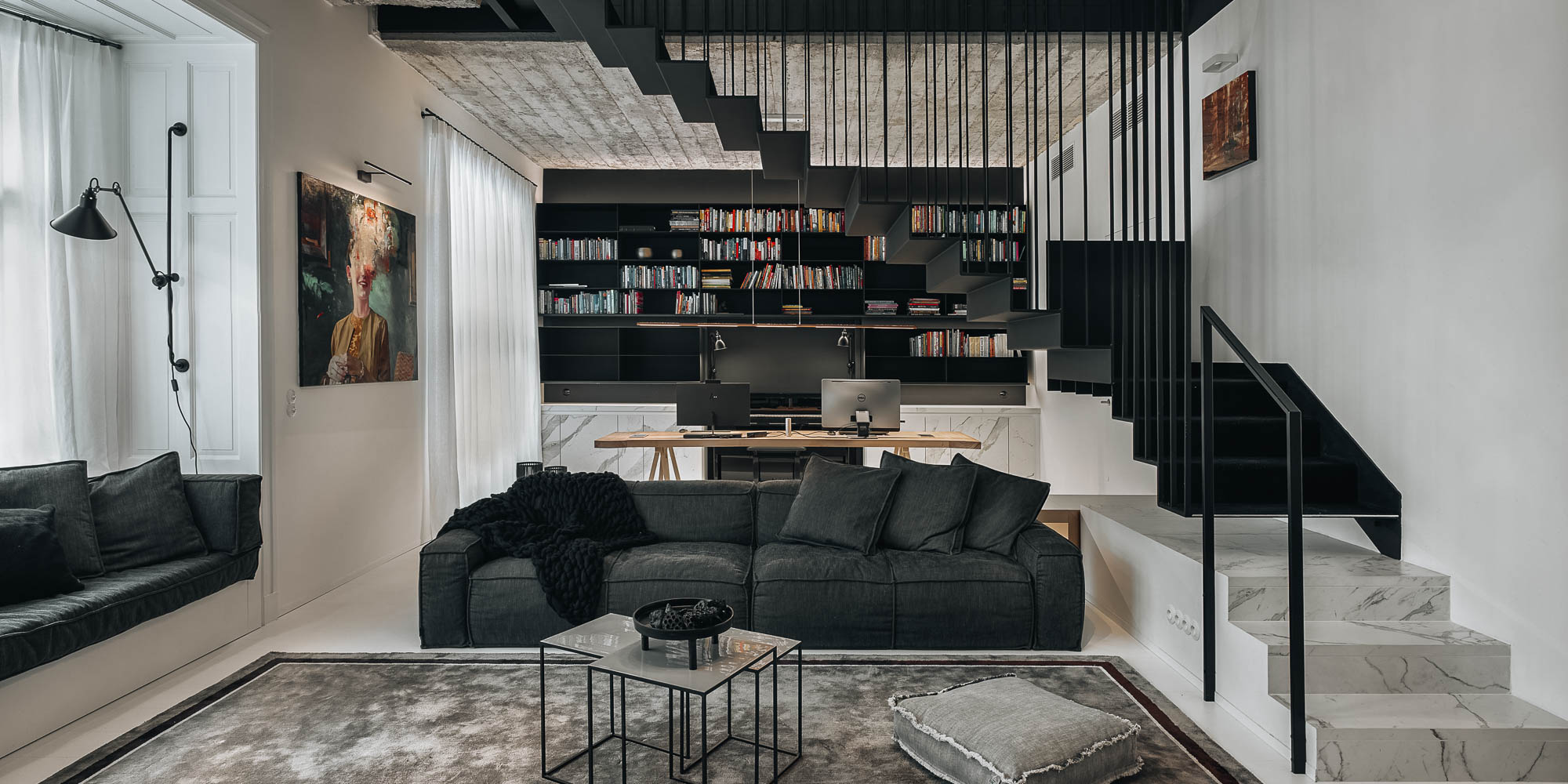 Living room exposed concrete ceiling black steel staircase dark grey sofa open bookshelf home office Prague OOOOX