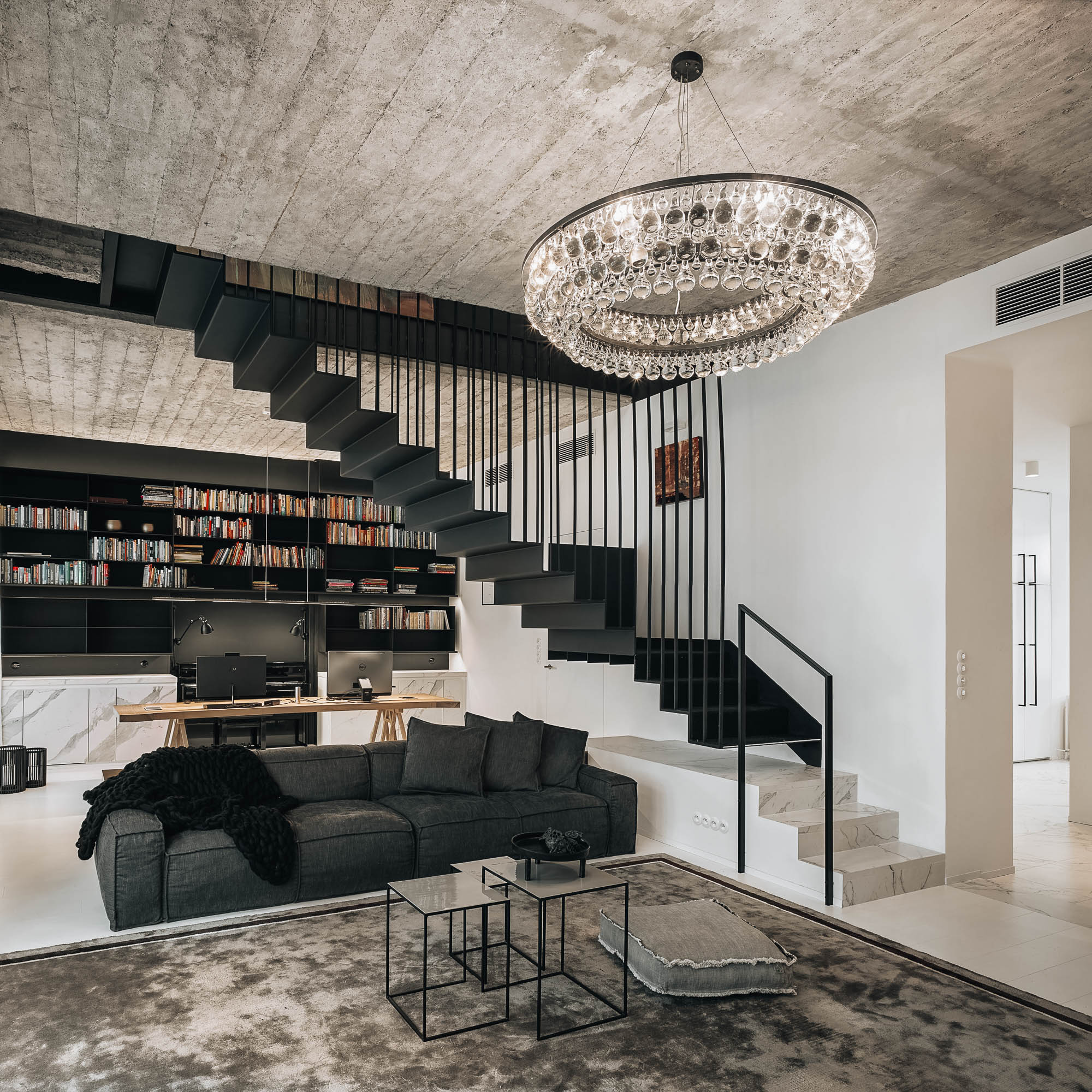 Living room crystal chandelier exposed concrete ceiling dark sofa black staircase bookshelf home office OOOOX