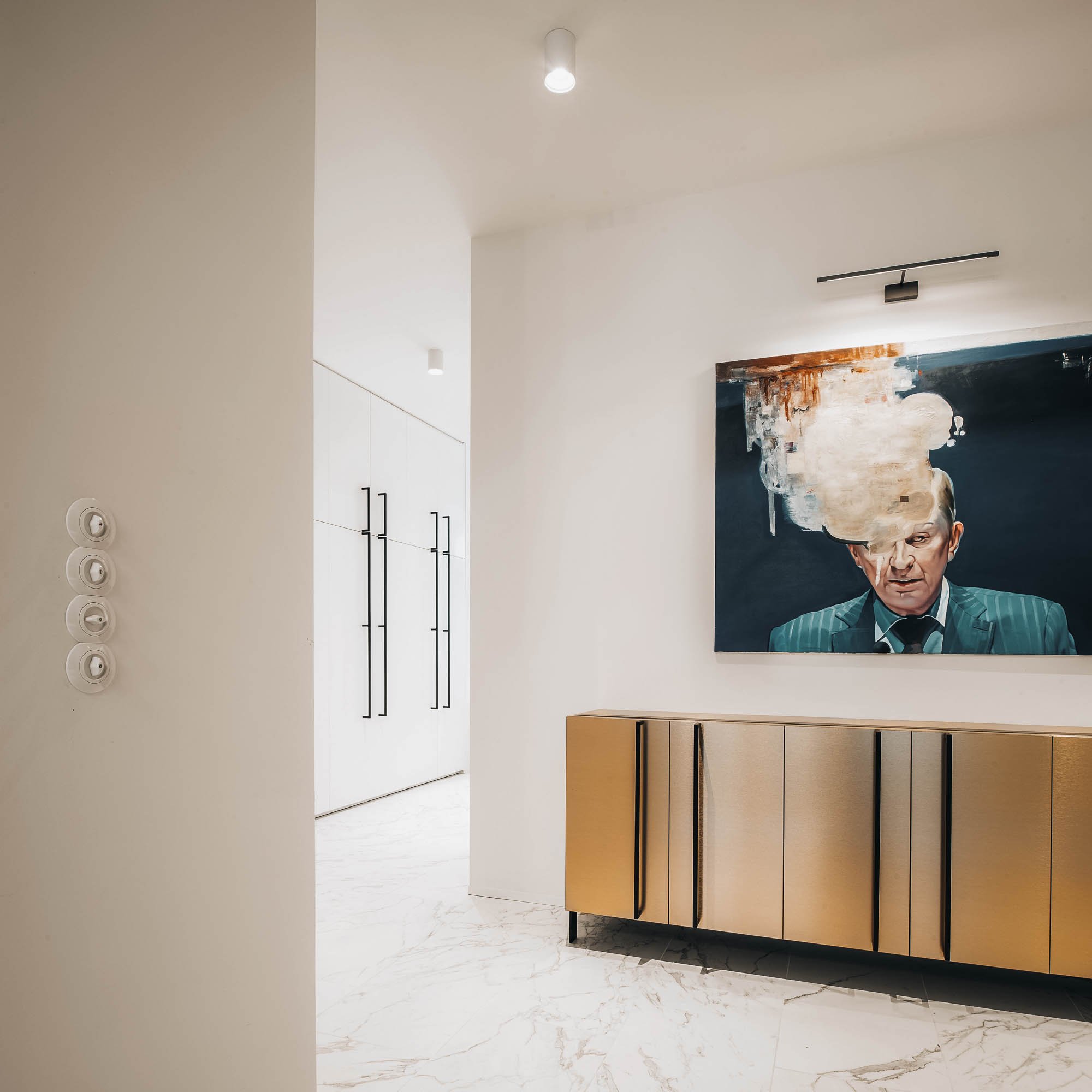 Entrance corridor white marble floor gold sideboard figurative painting white wardrobes round light switches OOOOX