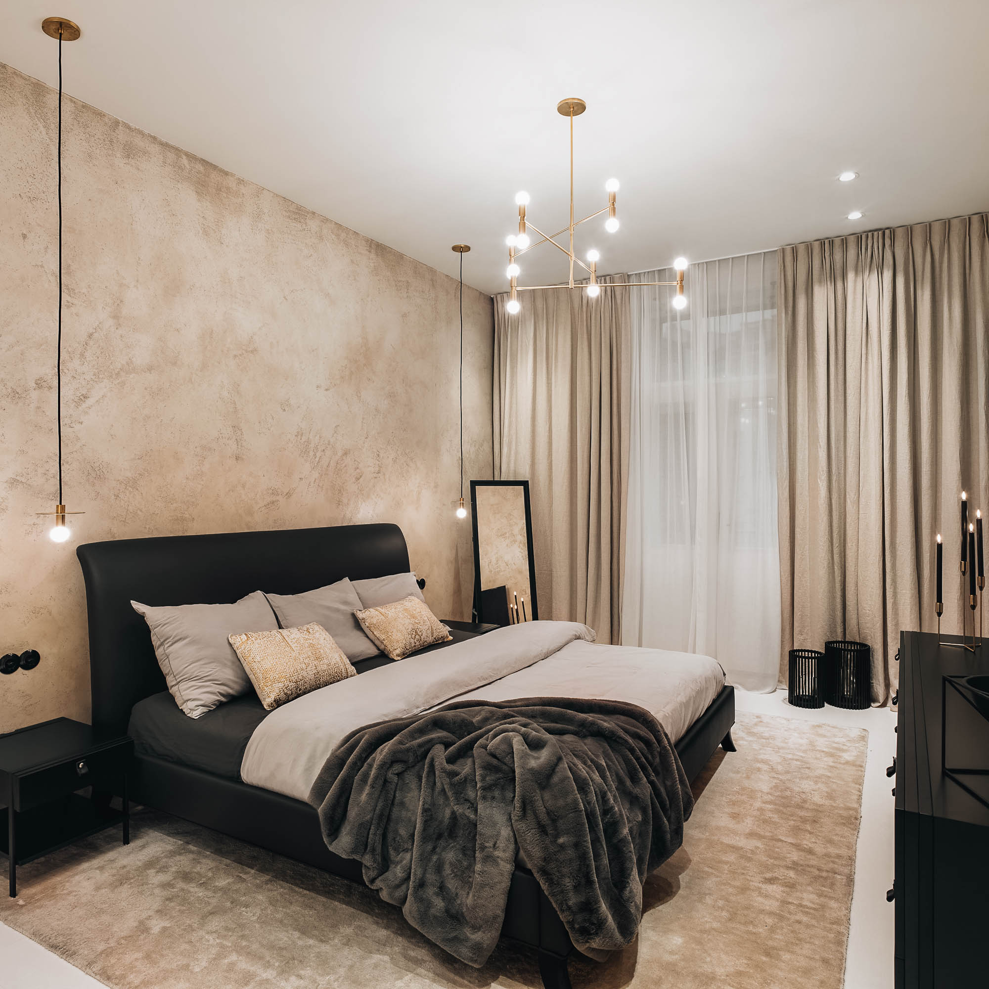 Bedroom anthracite leather bed warm beige stucco feature wall gold brass geometric chandelier linen curtains OOOOX
